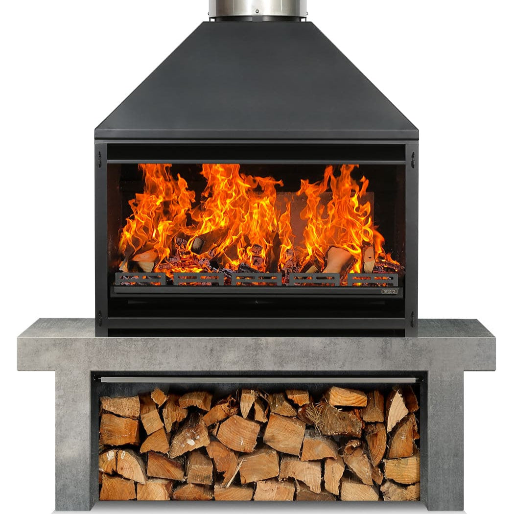 A black outdoor wood-fired braai (barbecue) with a fire burning inside it, and a storage area beneath for wood. It is placed against a white background.