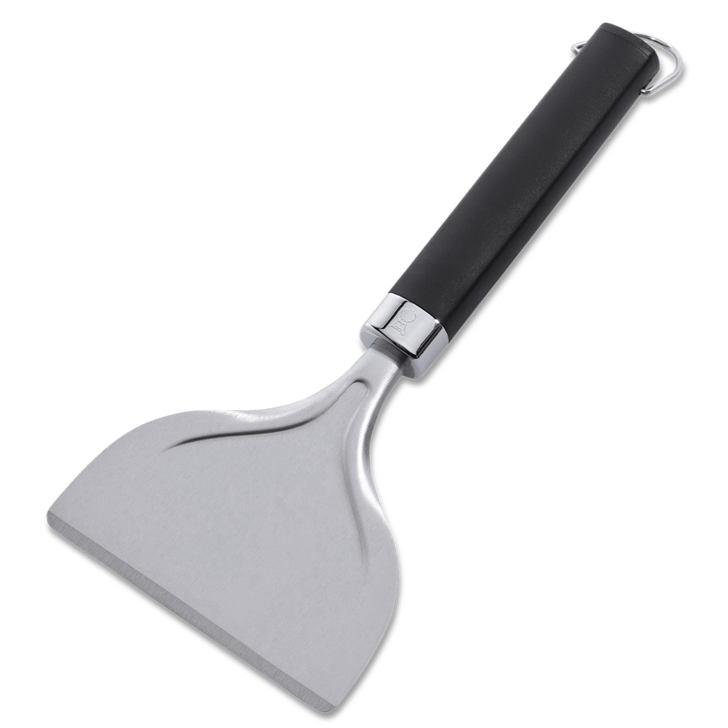 Weber Griddle Scraper with no-slip handle cleaning grease and grime from a barbecue griddle.