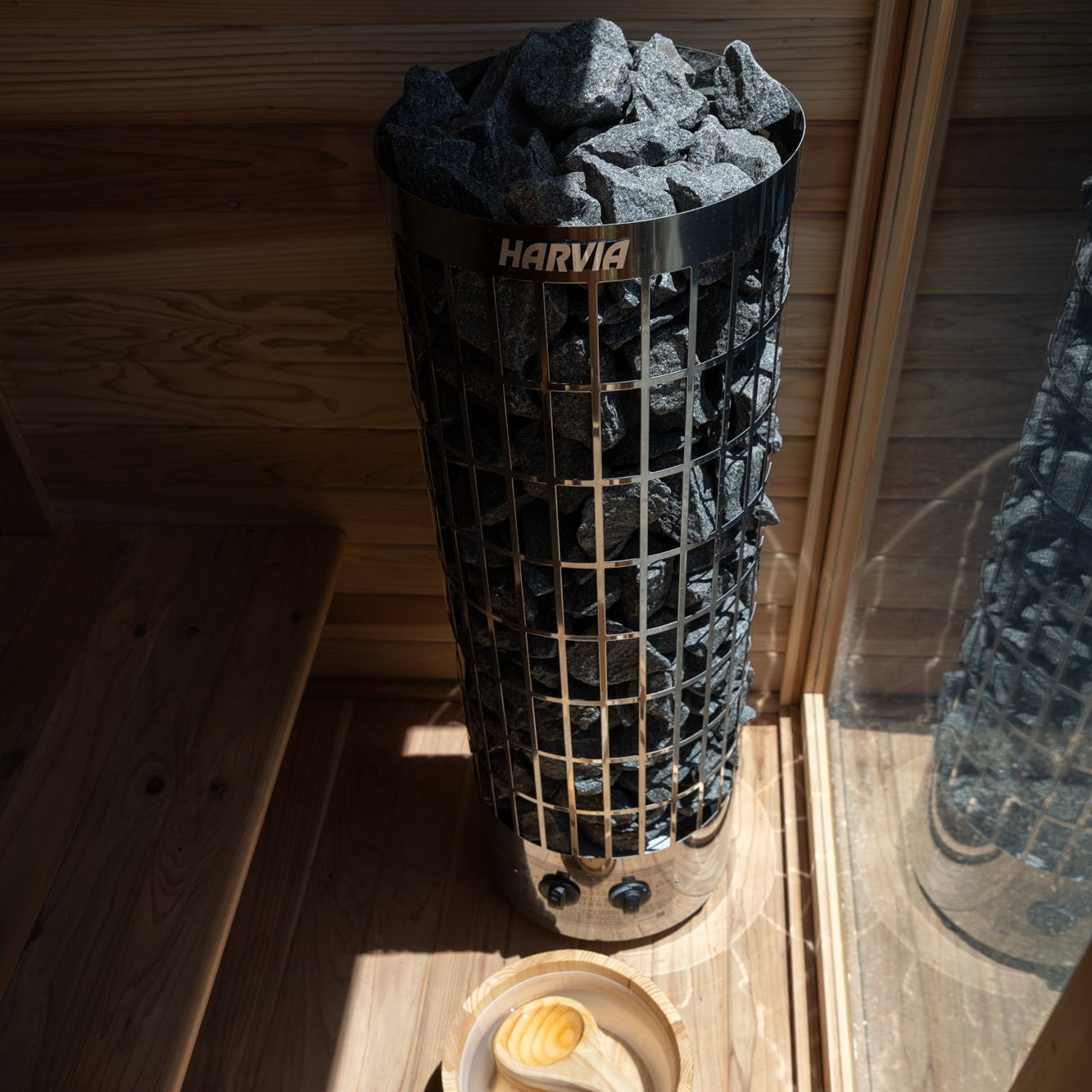 Sereno cedar outdoor sauna with stone heater in a New Zealand backyard setting